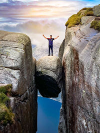 Rear view of man standing on rock