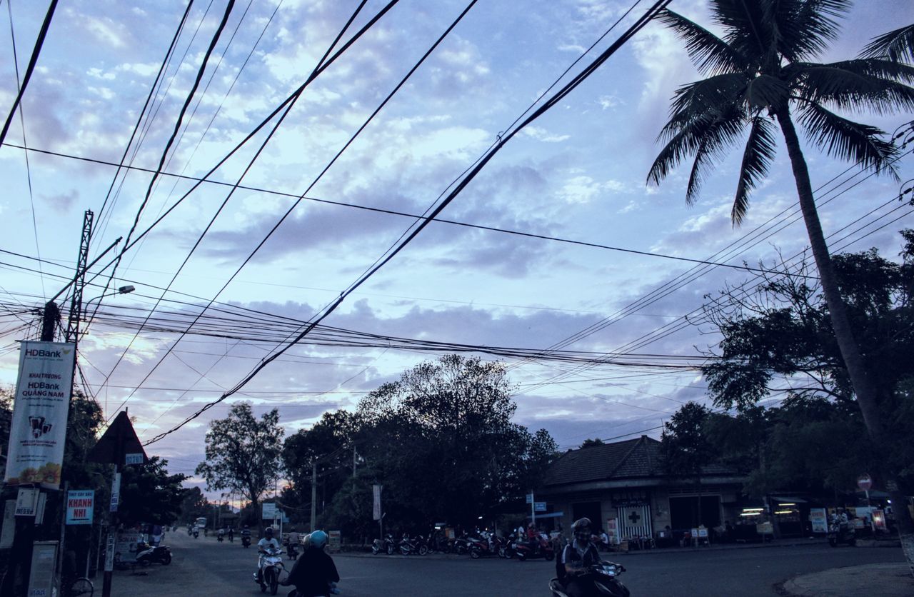 CARS ON ROAD AGAINST CLOUDY SKY