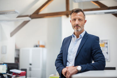 Portrait of confident mature businessman in office