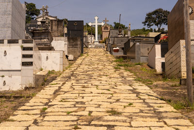 Footpath amidst buildings in city