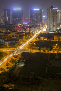 Aerial view of city lit up at night