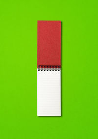 Directly above shot of open book against green background