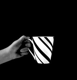 Cropped image of hand holding over black background