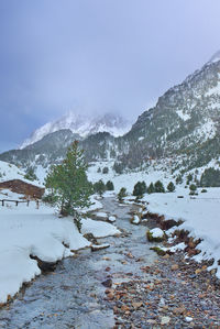 Water flowing down the river through the snow