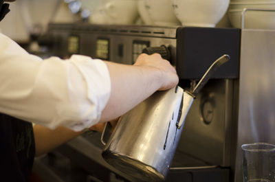 Midsection of man working in kitchen