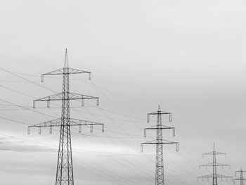 Low angle view of electricity pylon against sky