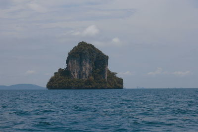 Scenic view of rock formation in sea against sky