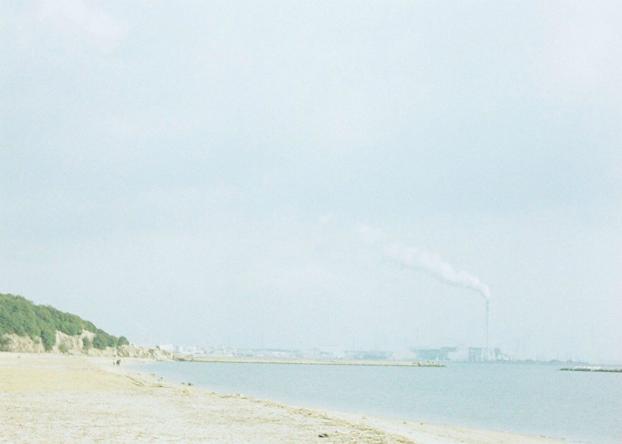 copy space, clear sky, water, tranquil scene, tranquility, sky, beach, nature, sea, scenics, weather, beauty in nature, day, outdoors, built structure, transportation, connection, sand, landscape