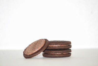 Close-up of cookies on table against white background