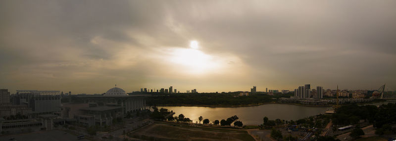 High angle view of buildings against cloudy sky