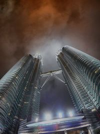 Low angle view of illuminated buildings against sky at night