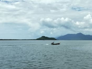 Boat sailing in sea against sky