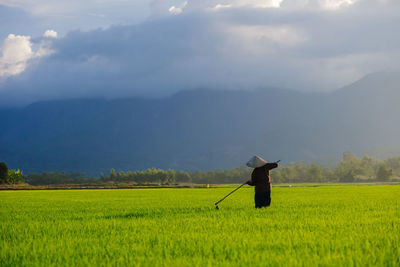 Person working on field against sky