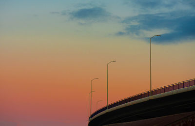 Low angle view of bridge against sky at sunset