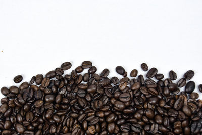 Close-up of coffee beans against white background