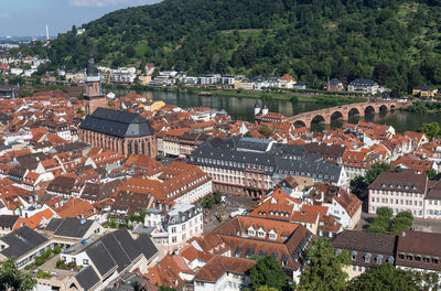 High angle view of townscape by river in city