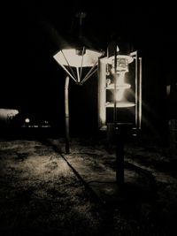 Illuminated street light on footpath at night