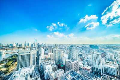 High angle view of buildings against blue sky