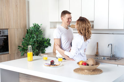 Young woman standing by food at home