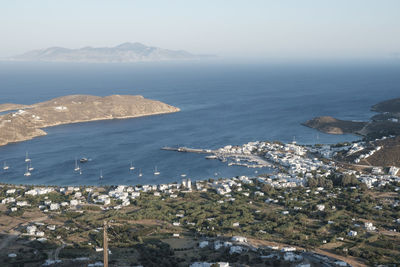 High angle view of townscape by sea against sky