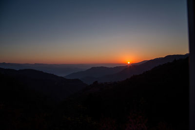 Scenic view of silhouette mountains against sky during sunset