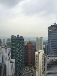 City skyline against cloudy sky