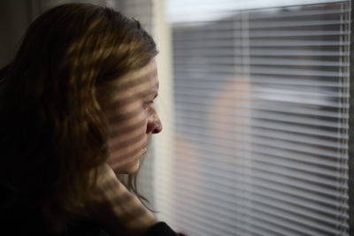 View of woman looking through window