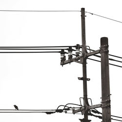 Low angle view of power lines against clear sky