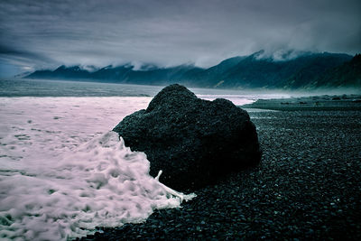 Scenic view of sea against cloudy sky