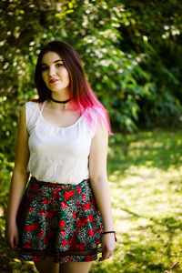 Young woman walking on field in park