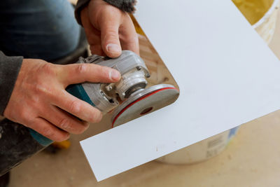 Midsection of man working on table