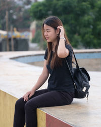 Young woman sitting outdoors