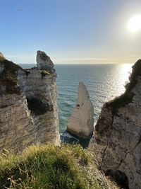 Rocks on sea shore against sky