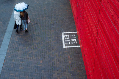 High angle view of sign on cobblestone street in city