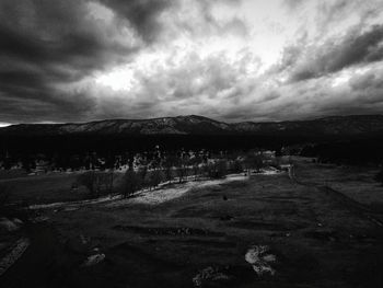 Scenic view of landscape against cloudy sky