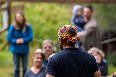 Rear view of people standing outdoors