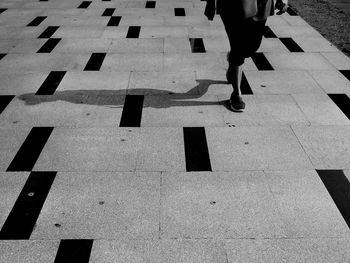 Low section of woman walking on footpath