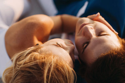 Close-up portrait of woman relaxing outdoors