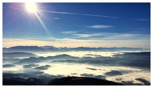 Scenic view of mountains against blue sky