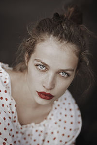 Close-up portrait of woman with bright eyes and red lipstick