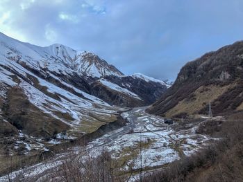 Scenic view of snowcapped mountains against sky