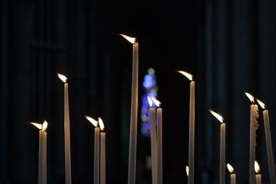 Low angle view of illuminated lighting equipment at night