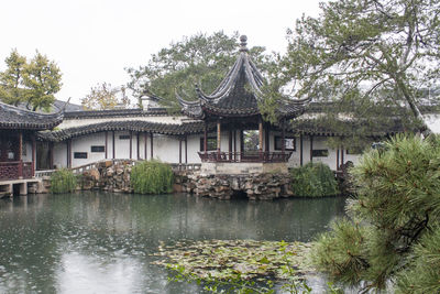 Buildings by lake at master of the nets garden