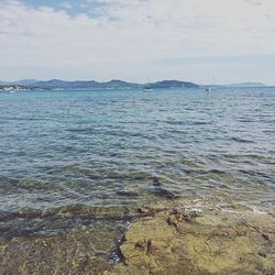 Scenic view of sea against cloudy sky