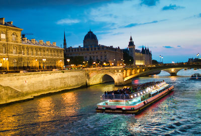 Boats in river with city in background