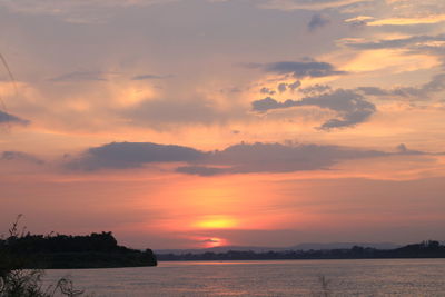 Scenic view of sea against romantic sky at sunset