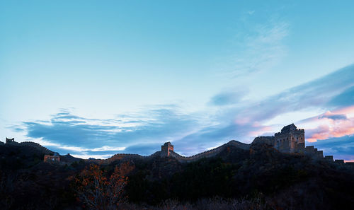 Low angle view of mountain against blue sky