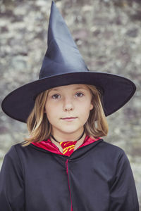 Portrait of young woman wearing hat standing outdoors