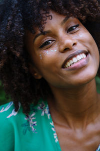 Portrait of a black woman with afro hair and glitter on her face