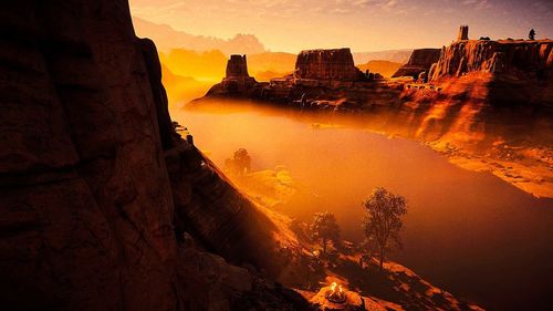 Scenic view of rock formations against sky during sunset